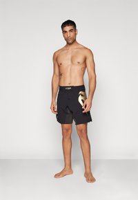 Venum RAPID FIGHTSHORTS - Sports shorts - black/gold