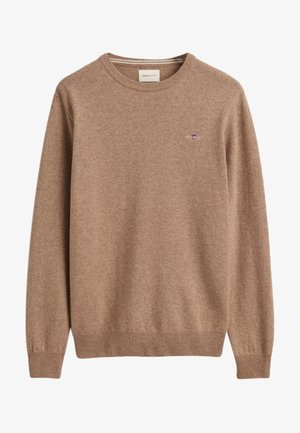 Brun stickad tröja med rund halsringning, ribbade ärmslut och nederkant. Litet broderat logotyp på bröstet. Mjuk, texturerad tyg.