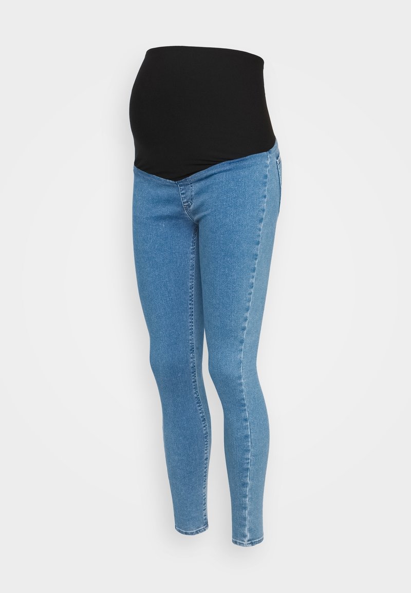 Jean de maternité bleu avec un panneau noir extensible conçu pour couvrir et soutenir le ventre.
