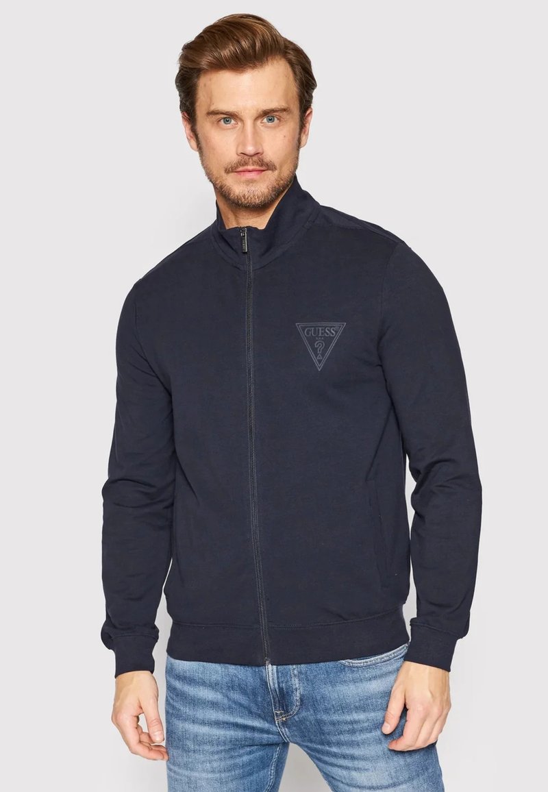 Giacca zip-up blu navy in cotone con colletto alto e logo tono su tono sul petto; presenta maniche lunghe e polsini aderenti.
