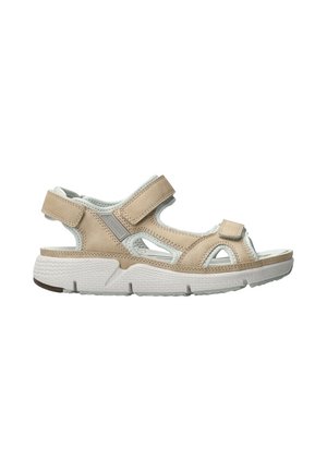 Sandale beige à bouts ouverts avec des brides réglables en Velcro, une semelle blanche rembourrée et un design respirant pour le confort et le soutien.