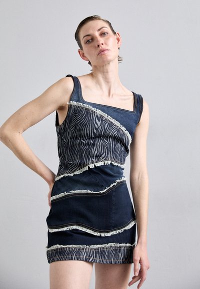 Denim dress featuring a zebra-striped pattern across the torso, with frayed edges and a fitted design in dark blue. Square neckline.
