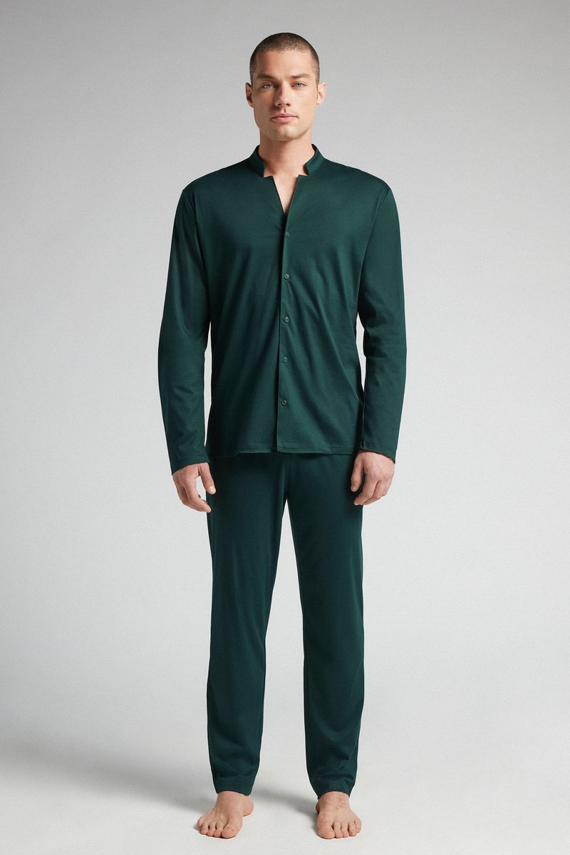 Dark green, long-sleeve button-up shirt paired with matching pants. Soft, smooth fabric, relaxed fit, minimalistic design with a collarless neckline.