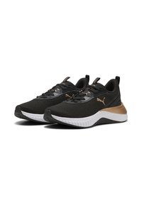Scarpe da ginnastica nere con parte superiore in mesh testurizzato, accenti dorati, suola in bianco e nero imbottita e sistema di allacciatura tradizionale.