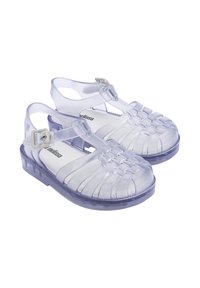 Sandali in gelatina viola traslucida con un design intrecciato, cinturino alla caviglia regolabile e suola texturizzata. Struttura leggera e flessibile.