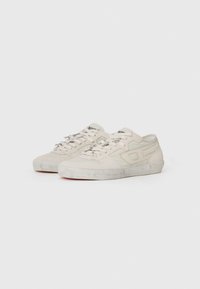 Beige suede sneakers with textured accents, featuring silver hardware, laces, and a rubber sole. Slight scuff marks visible on the sole.