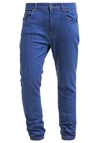 Blå denimjeans med en avsmalnande passform, som har knäppning, bältesloopar och framfickor. Tyget har en mjuk textur.