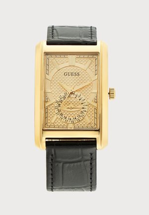 Правоъгълен часовник Guess с тъмен цвят на циферблата, златисти стрелки, черна кожена каишка и кръгъл дисплей за дата в долния център.