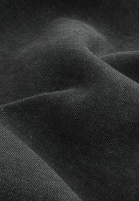 Black fabric with a soft, textured surface, featuring a slightly varied weave and smooth drape, highlighting depth in color and material quality.