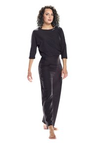 Black, loose-fitting top with a scoop neck and three-quarter sleeves, paired with high-waisted black pants. Smooth texture, minimalistic design.