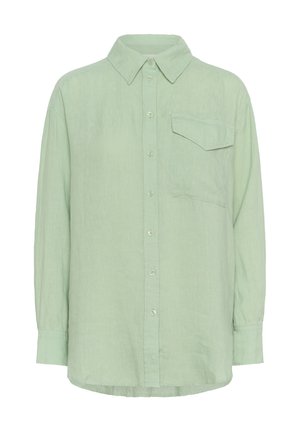 Cămașă lungă cu mânecă lungă de culoare verde deschis, confecționată dintr-un material texturat, având guler ascuțit, buzunar frontal și închidere cu nasturi.