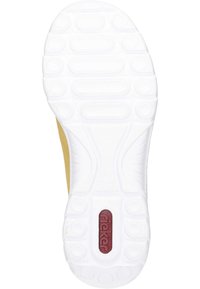 Shoe sole featuring a textured white rubber surface with circular gripping patterns, a yellow side, and a red "rieker" logo detail.