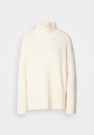 Cream-colored turtleneck sweater, crafted from textured knit fabric, featuring ribbed cuffs and hem, with a relaxed fit and side slits.
