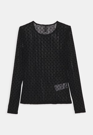 Black long-sleeve sheer top with velvet polka dots and round neckline, semi-transparent fabric showing a tag inside.