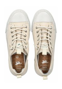 Sneakers di tela beige con punta in gomma bianca, lacci rotondi, sole in sughero e un'etichetta. Dettagli di cucitura lungo la suola.