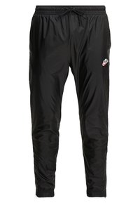 Svarta nylon joggerbyxor med elastisk midja, justerbar dragsnörning, smalnade muddar och en liten röd Nike-logotyp på vänster sida.