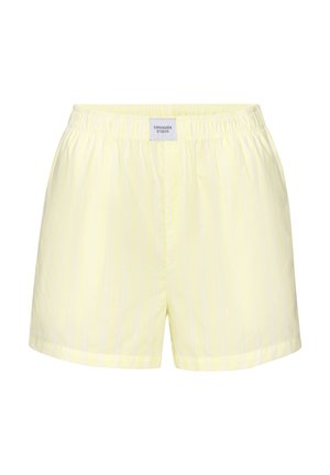 Hellgelbe Shorts mit elastischem Bund, dezenten vertikalen Streifen und einem kleinen rechteckigen Etikett mit der Aufschrift "Copenhagen Studios" mittig vorne.
