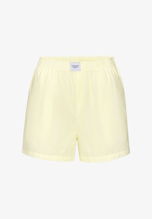 Hellgelbe Shorts mit elastischem Bund, dezenten vertikalen Streifen und einem kleinen rechteckigen Etikett mit der Aufschrift "Copenhagen Studios" mittig vorne.