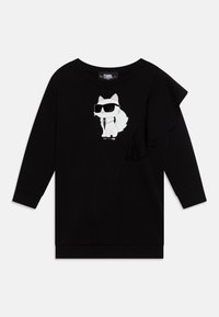 Sweatshirt noir à manches longues, avec un motif imprimé sur le devant représentant un chat en dessin animé portant des lunettes de soleil, et un accent froncé sur le côté gauche.
