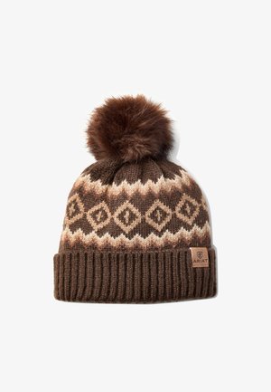 Brown knit winter hat with beige diamond pattern, ribbed cuff, large fluffy pom-pom on top, and small Ariat brand tag on cuff.