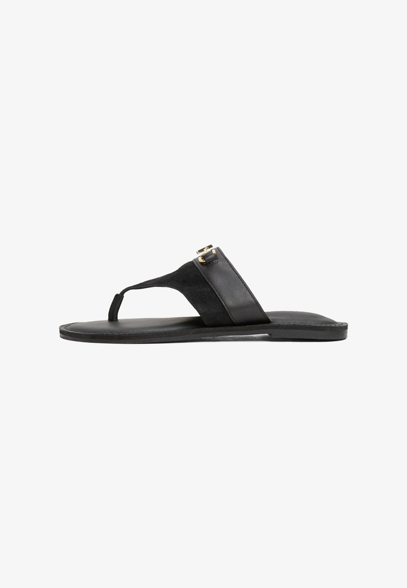 Fekete flip-flop szandál, velúrból készült felsőrésszel és bőr talppal. Nyakpánttal és aranyszínű kiegészítővel rendelkezik. Lapos talpú.