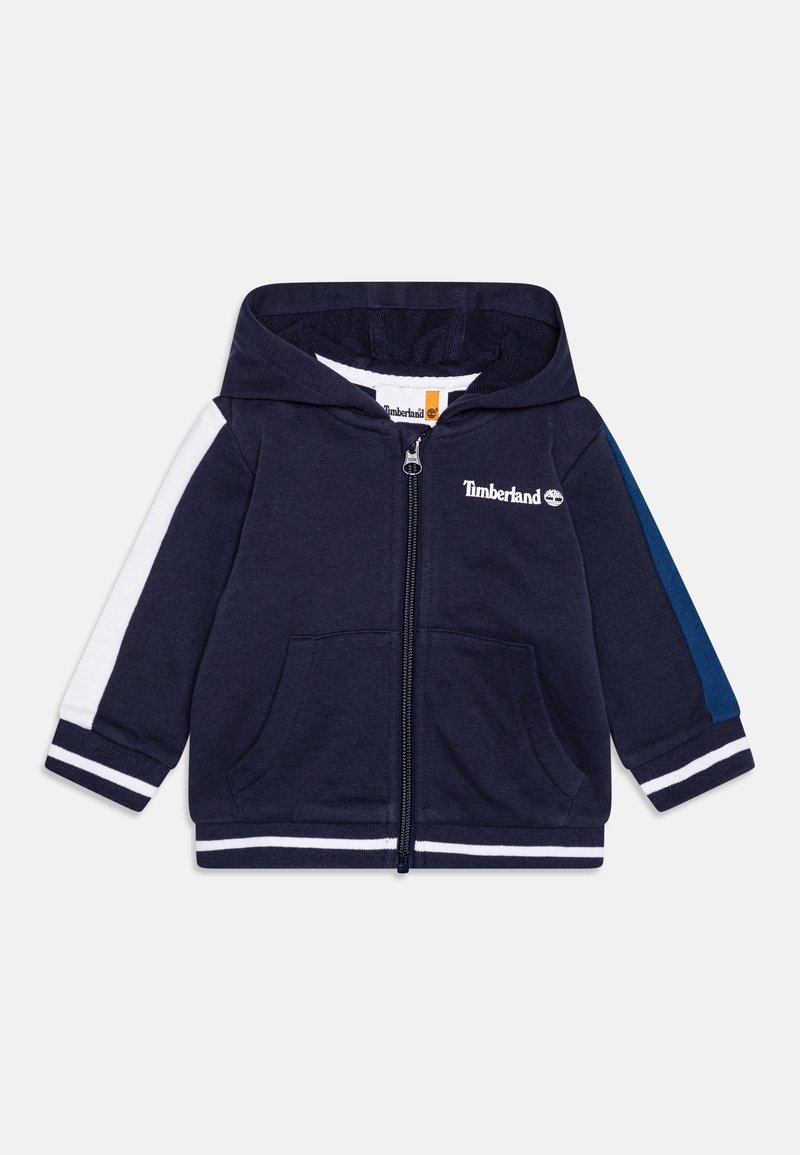 Sweat à capuche pour tout-petit bleu marine avec des rayures blanches et bleues sur les manches, poches avant, fermeture éclair complète et logo Timberland sur la poitrine.