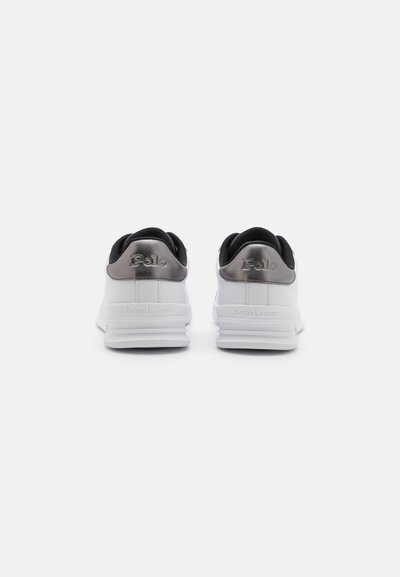 White and gray athletic shoes with black accents, featuring a smooth upper material, rounded edges, and embossed branding on the heel.