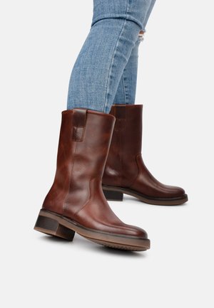 Brown leather ankle boots with a smooth texture, round toe, and stacked heel; minimal accent details and seamless design.