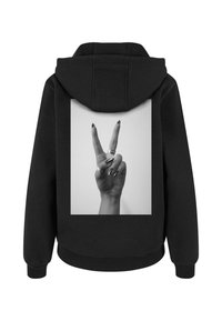 Sudadera negra con un gran gráfico en blanco y negro de una mano haciendo el signo de paz en la parte posterior. Tejido texturizado con un corte relajado.