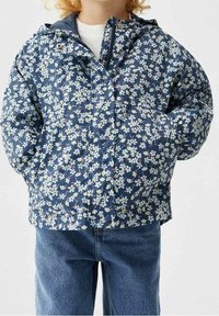 Navy blue puffer jacket with a floral pattern in white and pastel colors; features a hood, front pockets, and a zip closure.