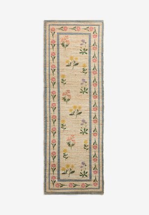 Tappeto rettangolare tessuto con sfondo beige, bordo blu e motivo floreale con fiori rosa, gialli e viola lungo il centro e i bordi.