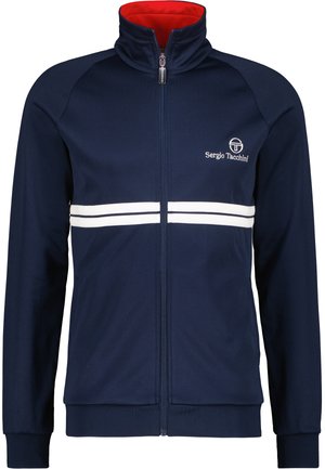 Marineblauwe trainingsjas met een rode binnenkraag, voorzien van witte horizontale strepen en een logo aan de bovenlinkerkant. Ritsluiting en geribbelde manchetten.