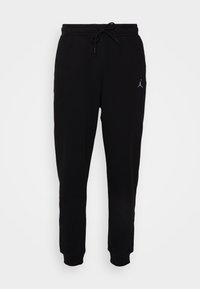 Schwarze Jogginghose aus weichem Stoff, mit einem elastischen Bund und Zugband sowie einem kleinen Logo am linken Oberschenkel.