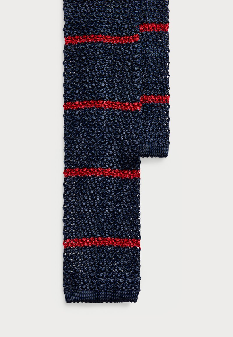 Navy knit scarf with red horizontal stripes, textured pattern, and ribbed ends. Material appears soft and lightweight.