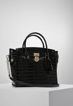 Black crocodile-patterned handbag with a glossy finish, top handles, gold hardware, and a detachable shoulder strap.
