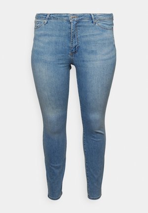 Skinny jeans in light blue denim, featuring a high waist, smooth texture, and minimalistic design with subtle fading and a zipper closure.