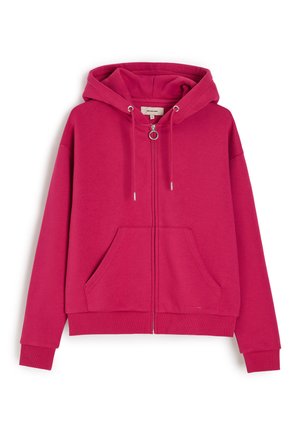 Jasnoróżowa bluza z kapturem na suwak, kaptur ze sznurkiem, przednie kieszenie, ściągacze i metalowa zawieszka zamka w kształcie pierścienia.