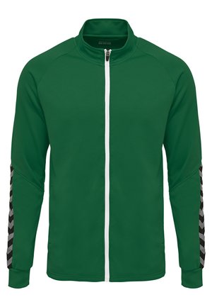 Groene zip-up jack met gestructureerde stof, witte rits en zwart-grijze gedessineerde accenten op de mouwen. Standaard kraag en mouwen van volledige lengte.