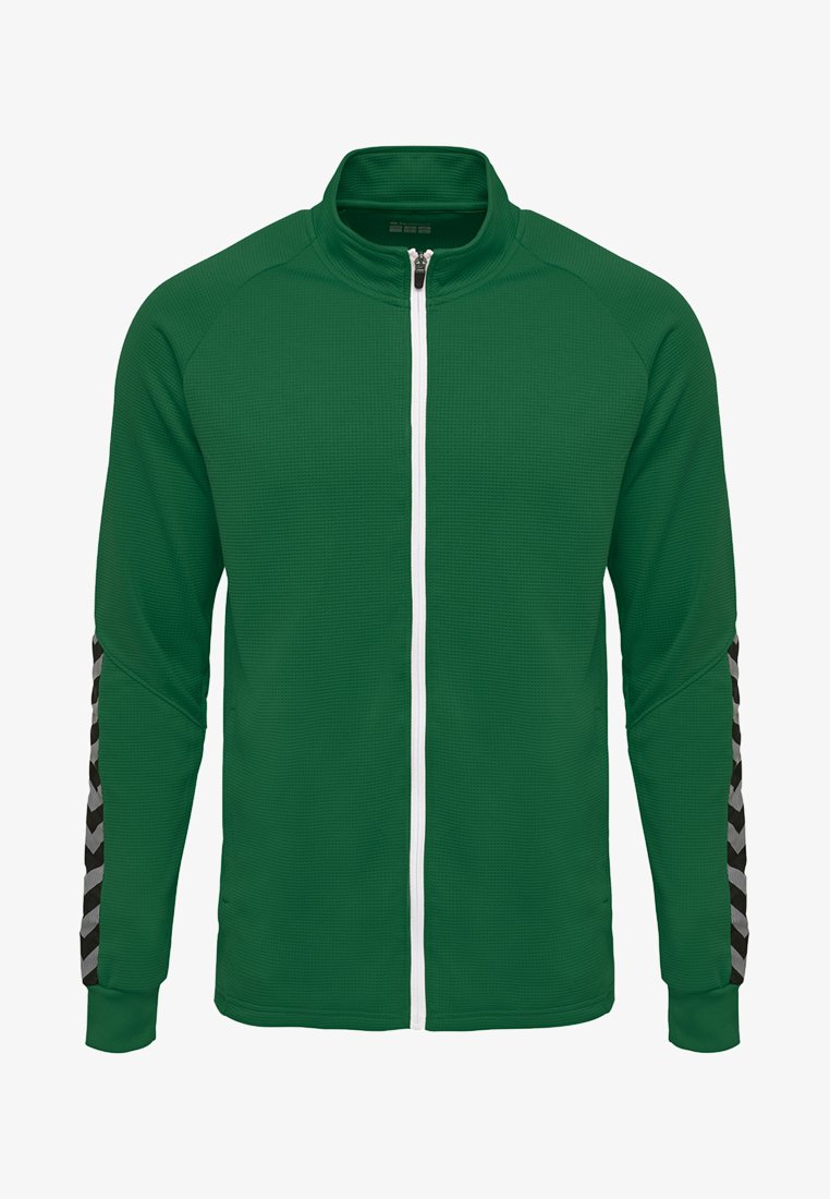 Grøn zip-jakke med tekstureret stof, hvid lynlås og sort-grå mønstrede detaljer på ærmerne. Standard krave og lange ærmer.
