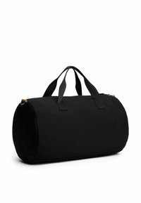 Sort duffel bag med rund form, stofmateriale, dobbelt håndtag og lynlåslukning. Har en lille metallisk detalje.