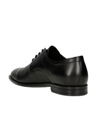 Chaussure habillée en cuir noir avec un côté texturé, bout arrondi et finition lisse. Dispose de lacets et d'un talon bas et plat.