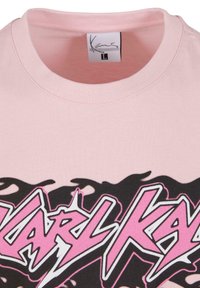 Light pink cotton t-shirt with a crew neck, featuring a bold black and pink graphic text "KARL KAY" across the front.