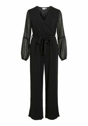 Melnas kombinezons ar iesaišu dizainu, garām caurspīdīgām puff piedurknēm, kas rotātas ar punktiņiem, un auduma jostu viduklī. Gluda tekstūra.