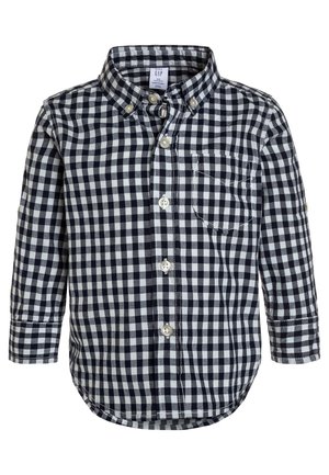 Camisa de manga larga para niños con patrón de cuadros en blanco y negro y bolsillo frontal en el pecho.