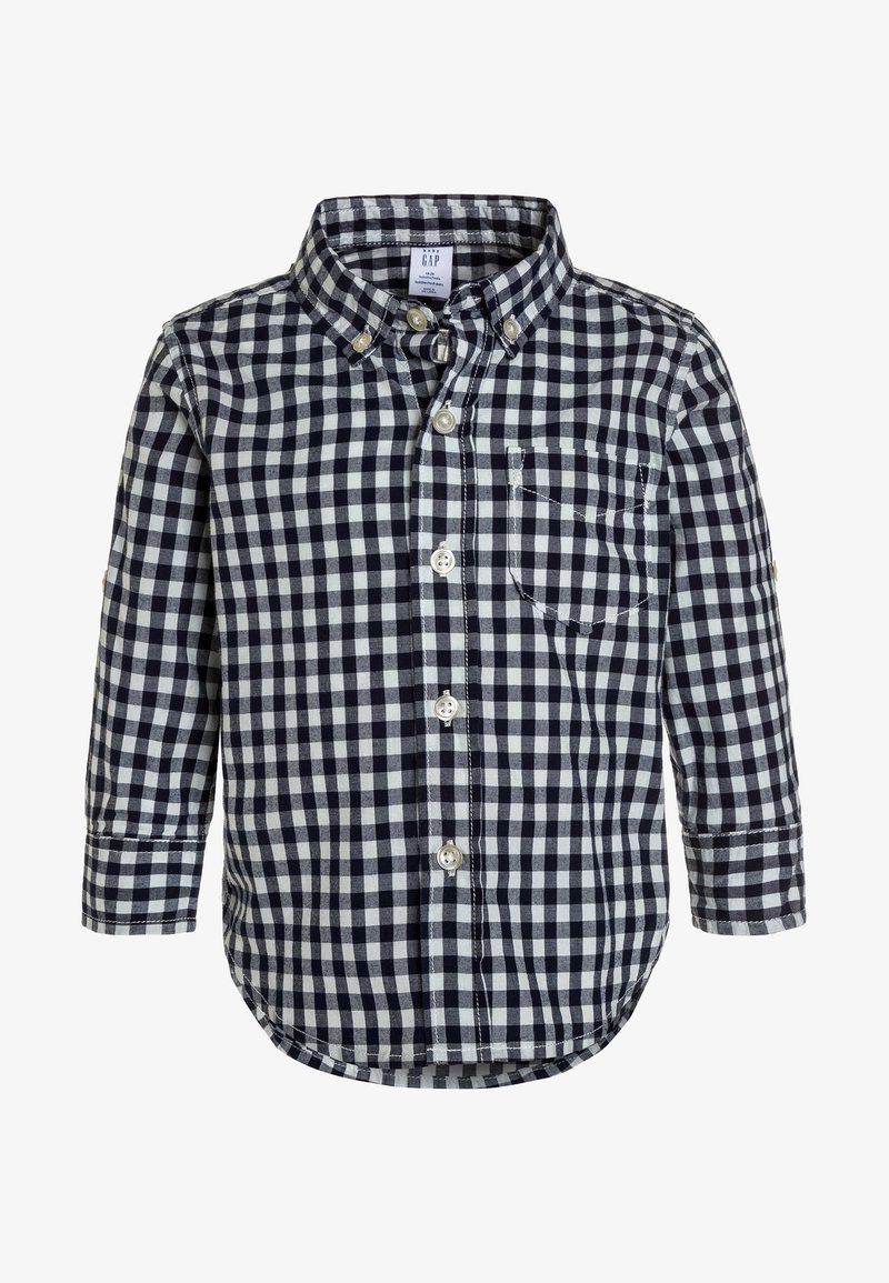 Chemise pour enfants à manches longues avec un motif à carreaux noir et blanc et une poche poitrine avant.