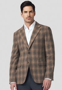 Brązowa marynarka w kratę z niebieskimi akcentami i dwoma guzikami. Posiada klapy w stylu notched oraz przednie kieszenie, wykonana z teksturowanej wełny.