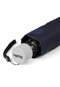 Ergonomic umbrella with a dark fabric cover, blue geometric accents, and a textured white handle featuring the "ergobag" logo.