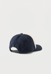 Tumedat sinelvardid kootud baseball müts, millel on reguleeritav snapback ja beež fliisvooder esipaneelil ja äärel.