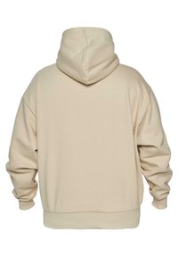 Sudadera de gran tamaño beige con capucha, mangas largas y puños y dobladillo acanalados, mostrada desde la parte de atrás sobre un fondo blanco.