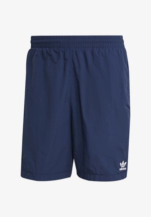 Tamnoplave Adidas hlačice s elastičnim pojasom, laganim materijalom i malim bijelim Adidas logotipom na donjem lijevom nožnom dijelu.